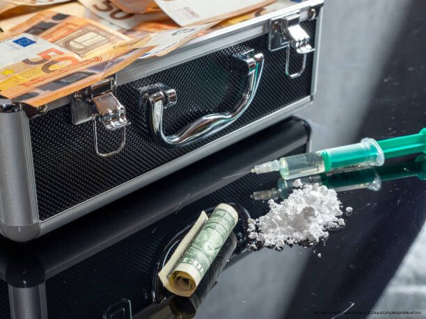 L'IMPACT DU TRAFIC DE DROGUE SUR LES GUERRES CIVILES ET LA STABILITÉ DES NATIONS 3 Money and drugs on a black glass table. Money, syringe and drugs.