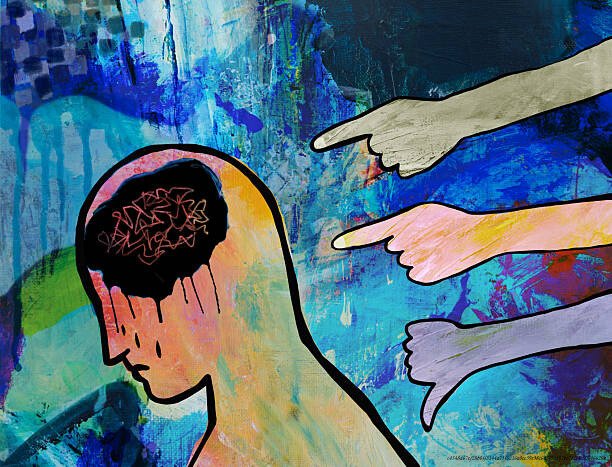 LES TROUBLES DISSOCIATIFS : QUAND LE CERVEAU SE DÉCONNECTE DE LA RÉALITÉ POUR SURVIVRE 5 People blaming, shaming, finger pointing at a man who looks down in shame